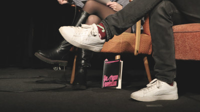 Medium close-up of Alice Cappelle's book "Collapse Feminism" on stage during a Culturitical Talk